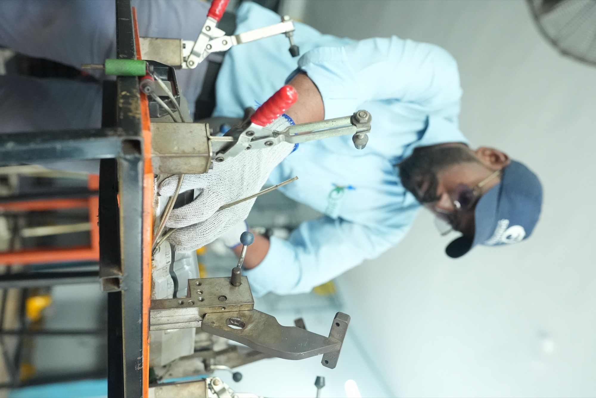 Gloved inspector seating a panel against the locators of a checking fixture