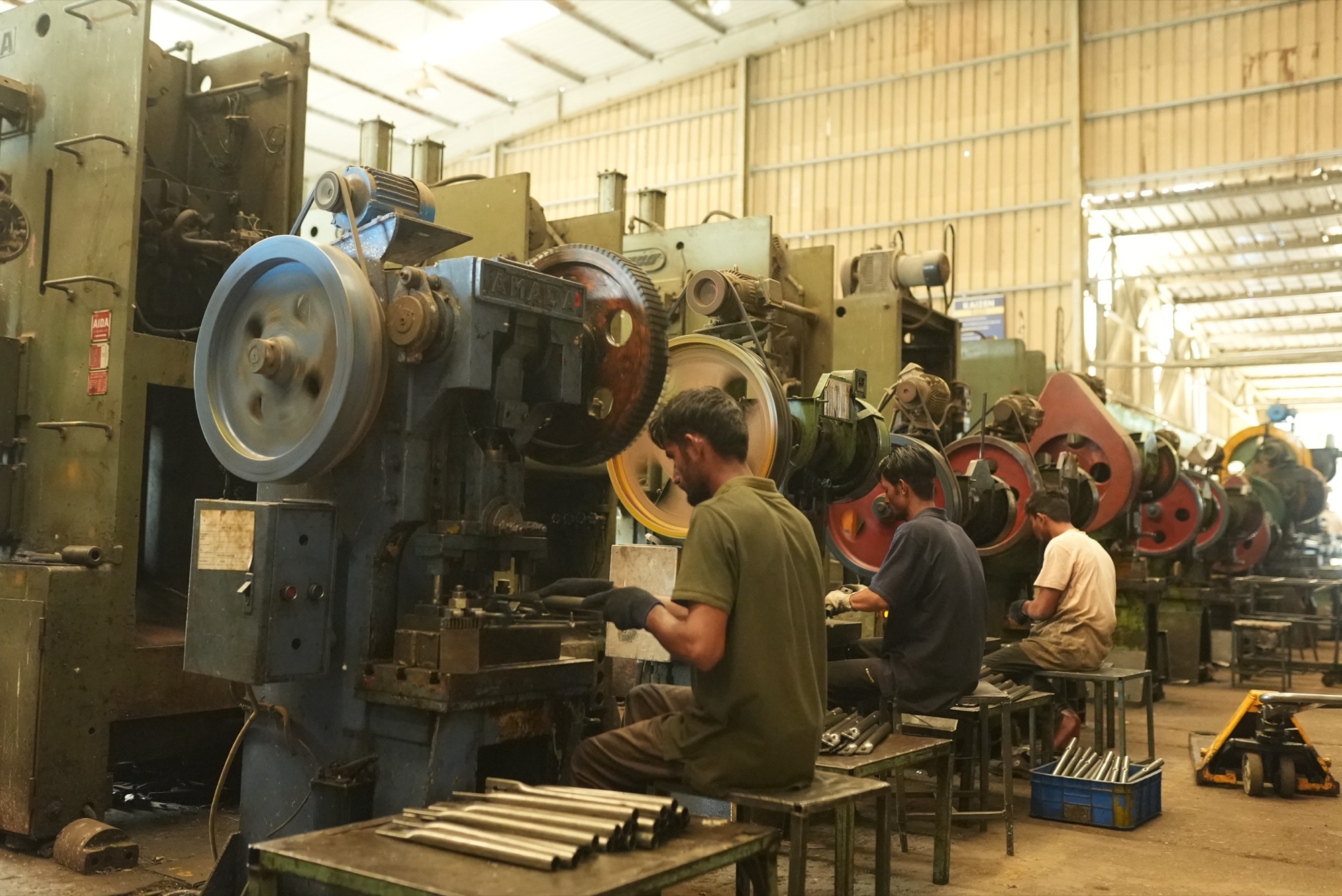 Operators running a line of mechanical power presses in the SAPL press shop