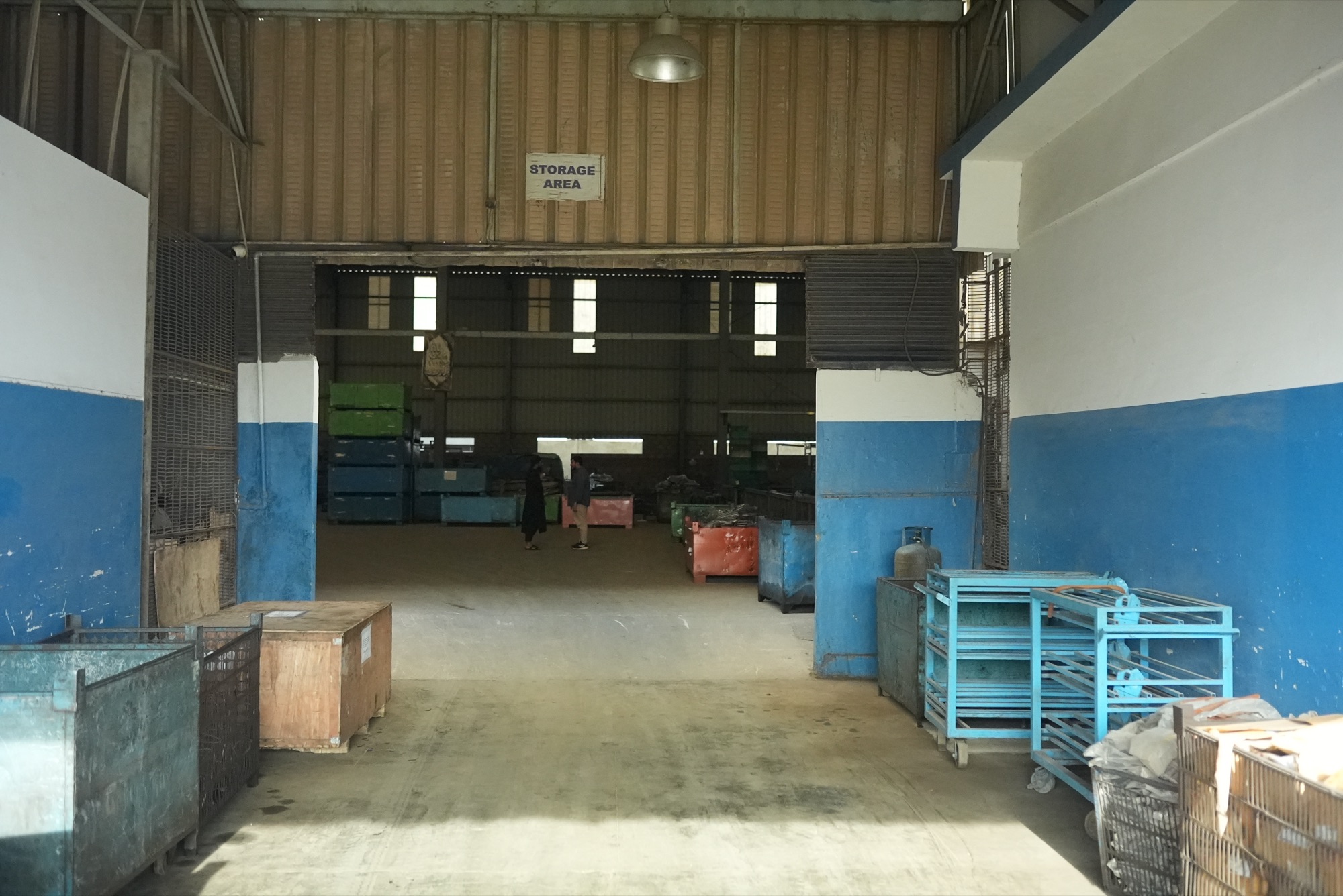 Entrance to the storage area with steel bins and part trolleys