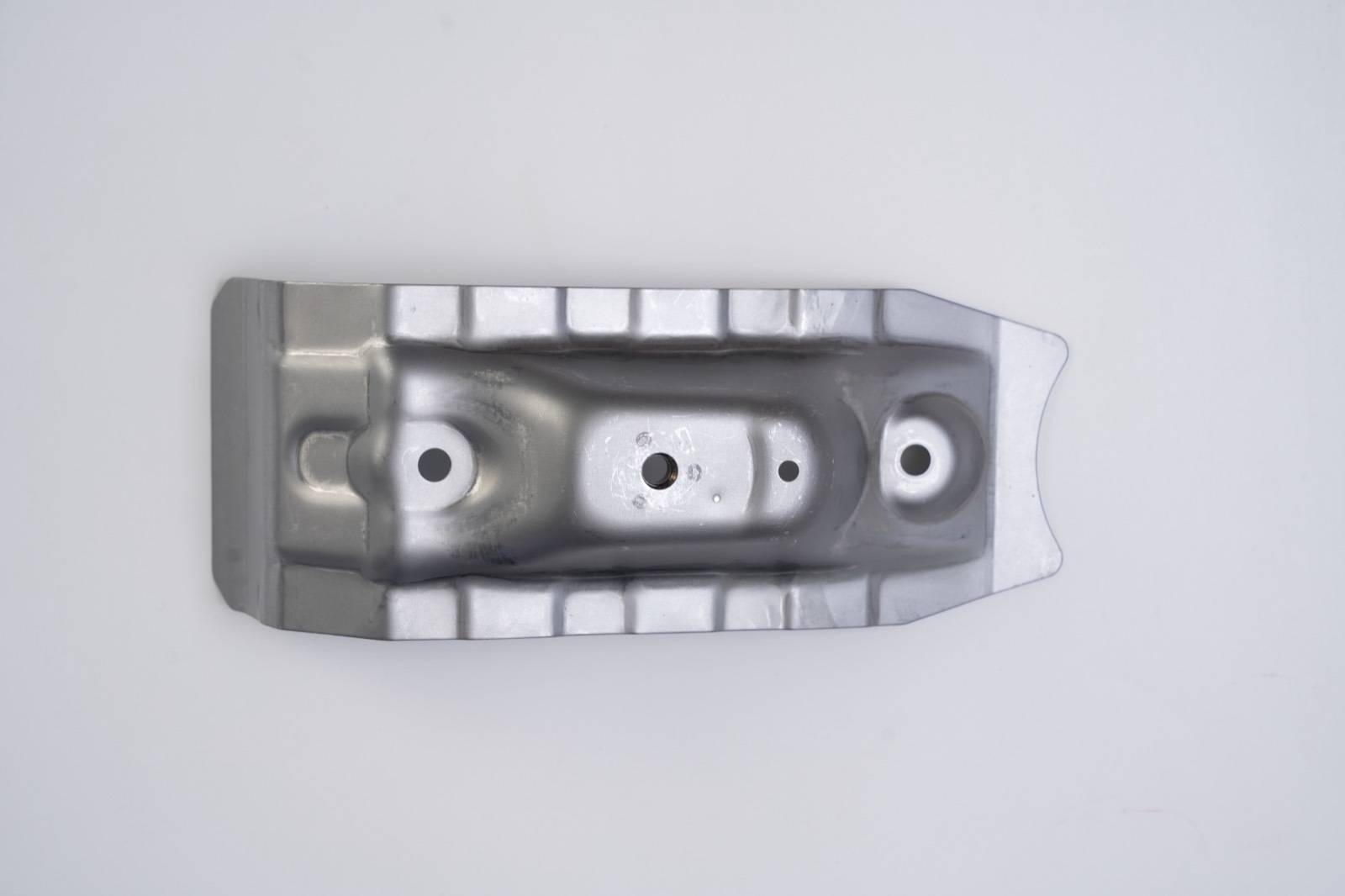 Deep-drawn channel bracket with ribbed flanges and pierced holes