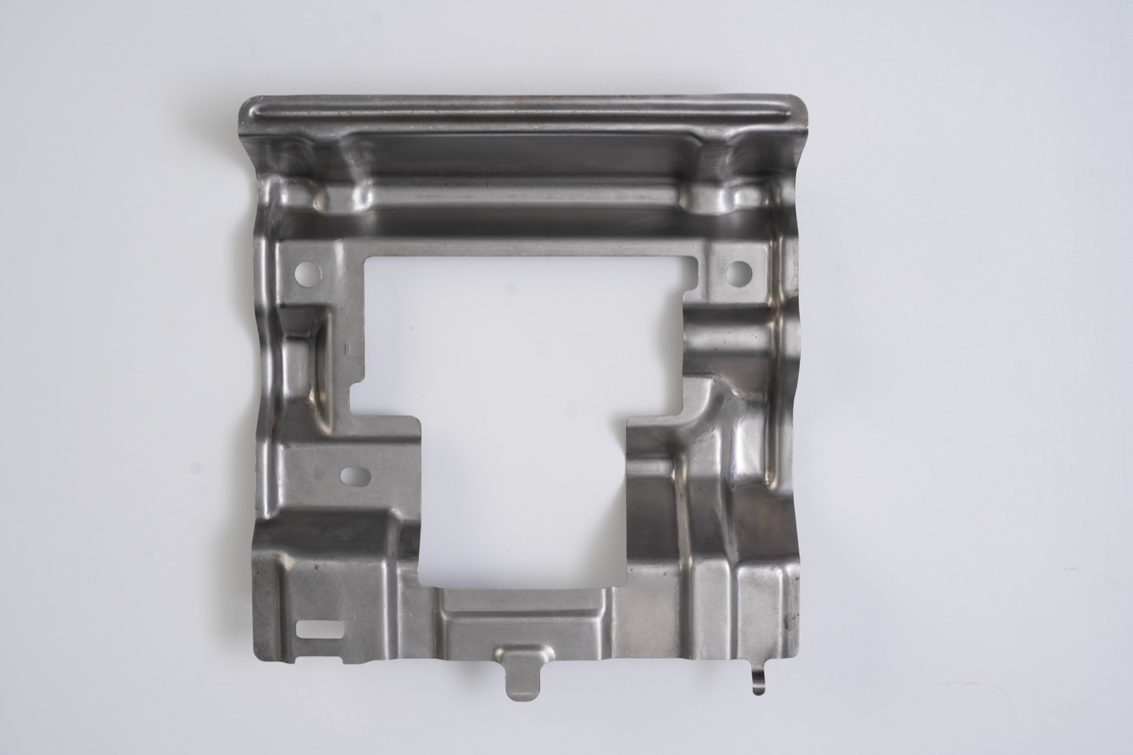 Deep-drawn frame bracket with central cut-out, reverse side