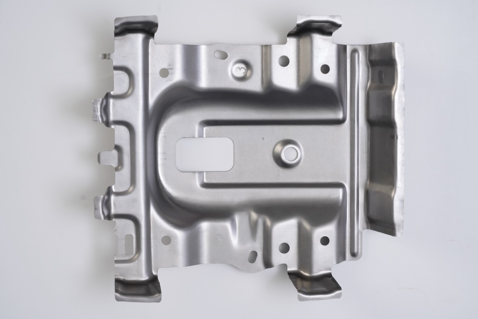 Stamped mounting plate with U-shaped embossing from an alternate angle