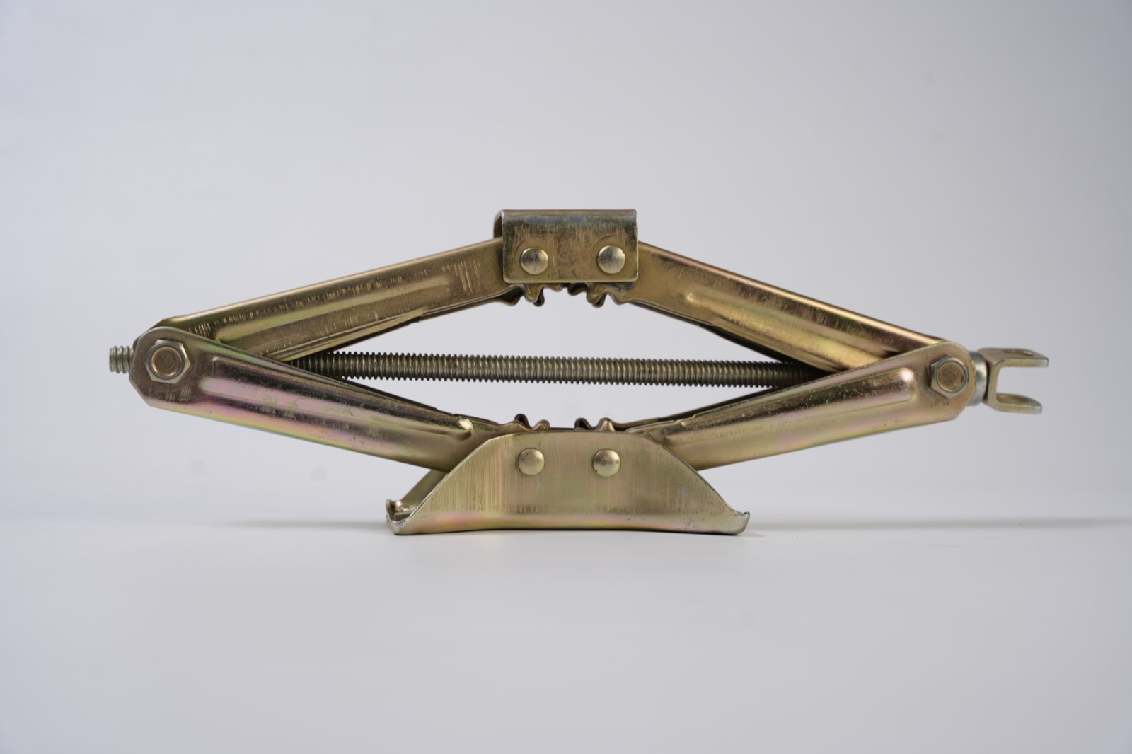 Yellow zinc scissor jack with riveted saddle, lead screw and clevis drive end