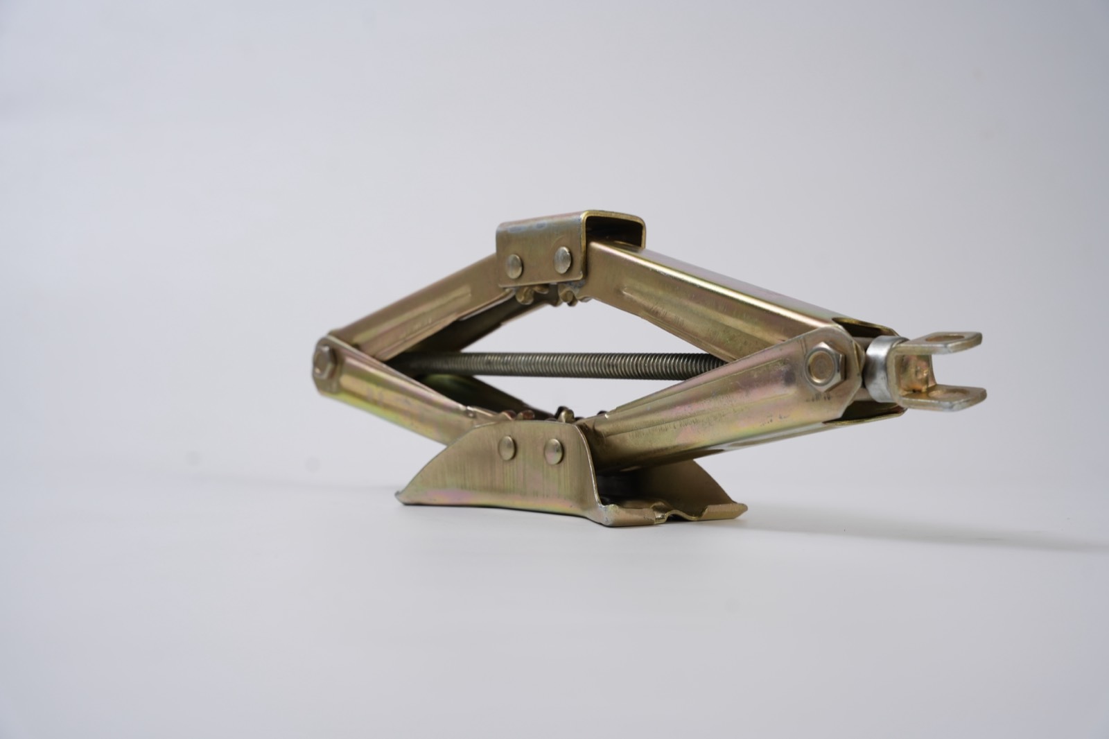 Yellow zinc scissor jack from an angled view