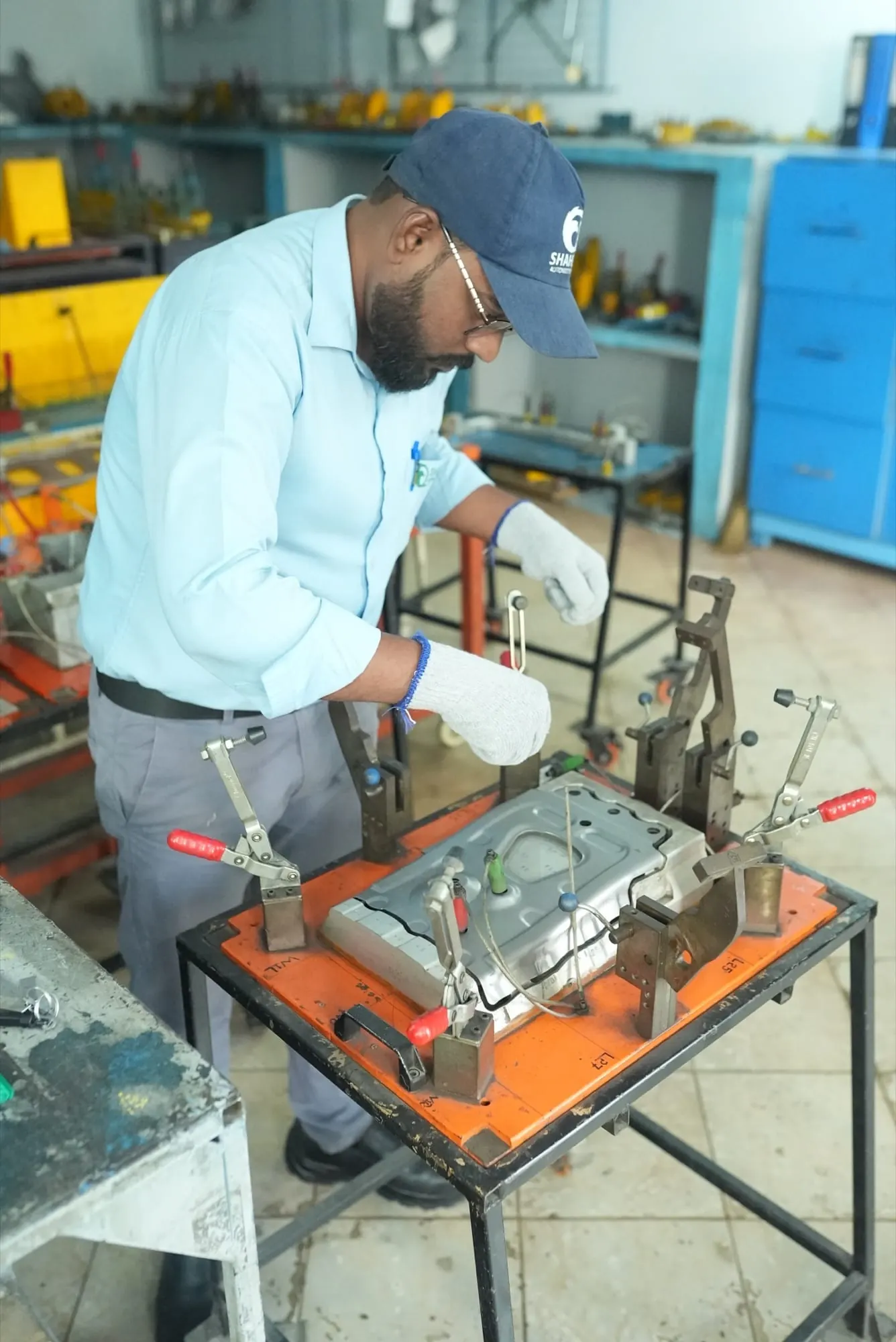 Inspector clamping a stamped sheet metal panel into a checking fixture